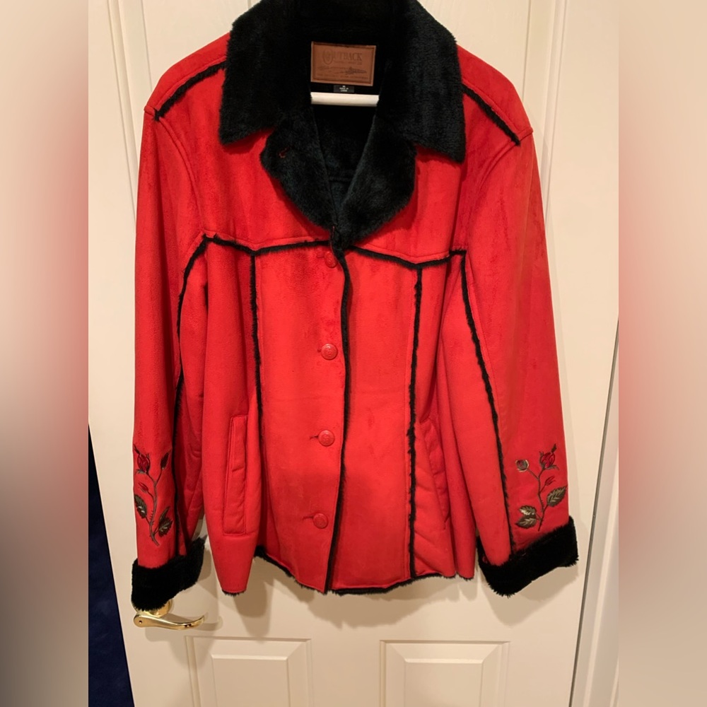 Red jacket with black fleece lining and embroidered sleeves
